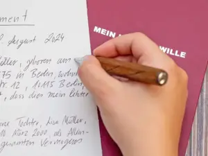 Jemand schreibt mit einem hochwertigen Tintenroller von Faber-Castell ein handschriftliches Testament auf ein Blatt Papier. Foto: Johanna Rundel